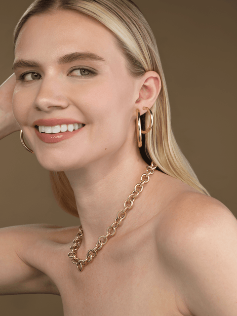 everyday gold hoop earrings styled on ear